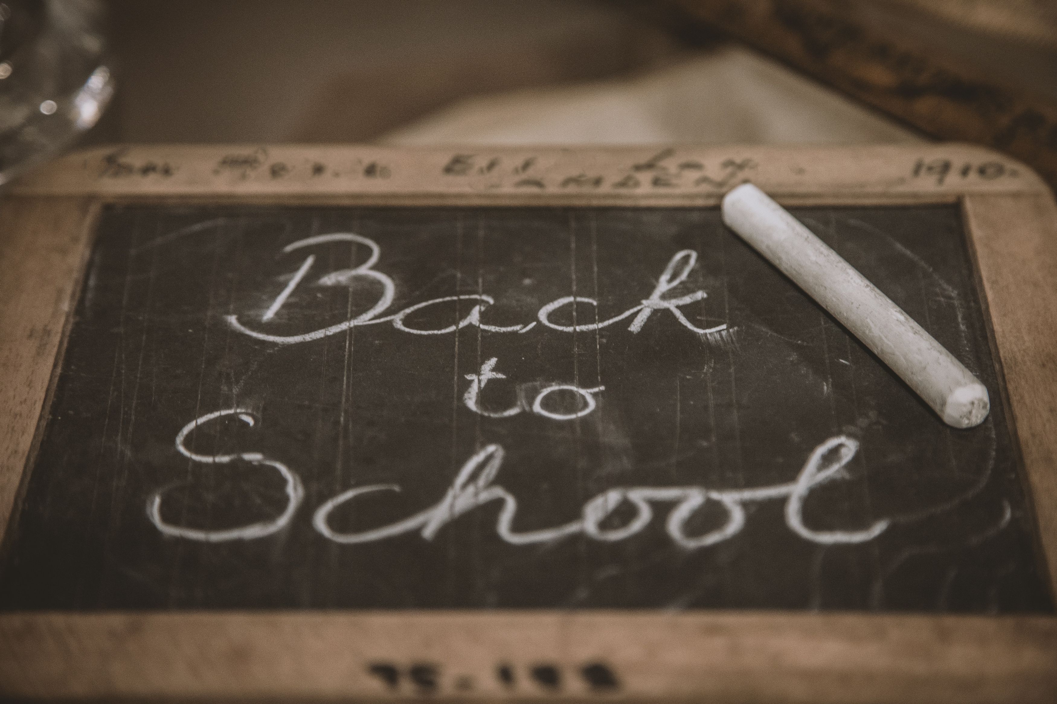 School handheld chalkboard with back to school written in chalk